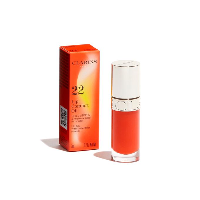 Imagem do produto Clarins Lip Comfort Oil laranja escuro da linha Power of Colors, apresentado ao lado da respetiva embalagem