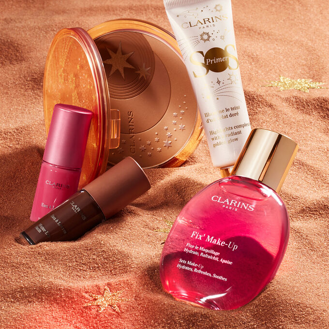Imagem de artigos de beleza essenciais para o verão, incluindo pó solar, batom Water Lip Stain, primer e fixador de maquilhagem